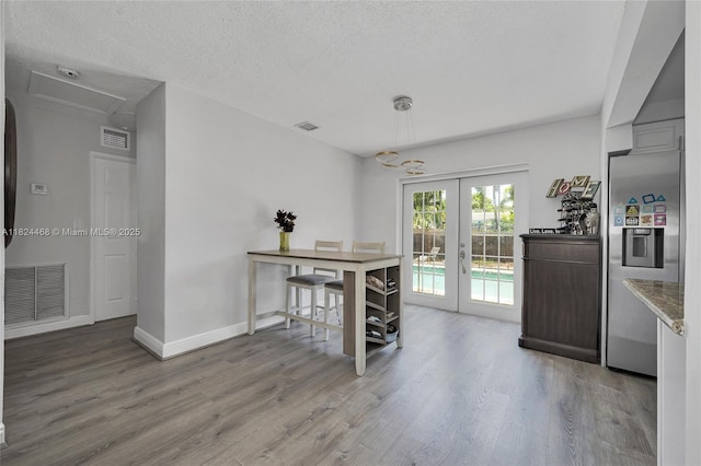 5576 SW 7th St, Margate, FL 33068 - dining room with wood finished floors, french doors, and a textured ceiling