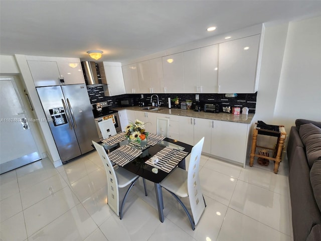 345 Ocean Dr Unit 602, Miami Beach, FL 33139 - kitchen with appliances with stainless steel finishes, backsplash, white cabinets, and recessed lighting