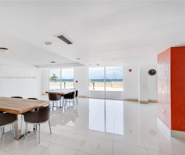 345 Ocean Dr Unit 602, Miami Beach, FL 33139 - dining area with a wall of windows and light tile patterned floors