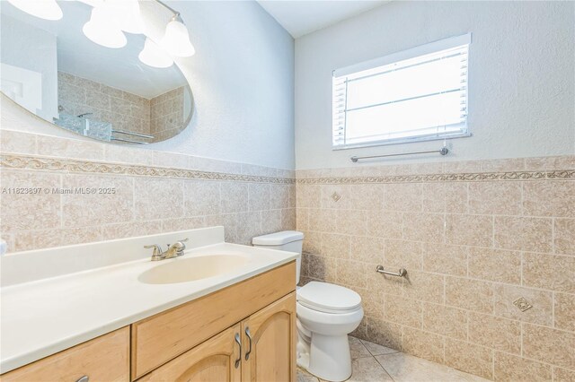 156 SW 126th Ave, Plantation, FL 33325 - bathroom with tile walls, vanity, tiled shower, wainscoting, and tile patterned flooring