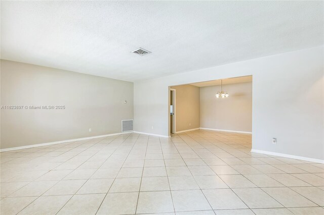 156 SW 126th Ave, Plantation, FL 33325 - unfurnished room with a chandelier, light tile patterned floors, and a textured ceiling