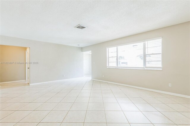 156 SW 126th Ave, Plantation, FL 33325 - spare room featuring a textured ceiling and light tile patterned flooring