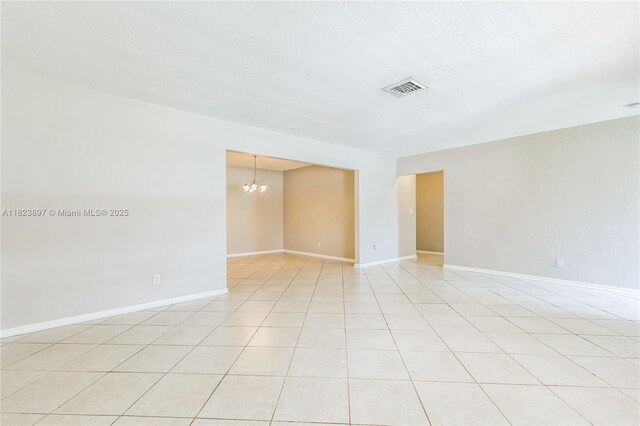 156 SW 126th Ave, Plantation, FL 33325 - empty room with a chandelier and light tile patterned floors