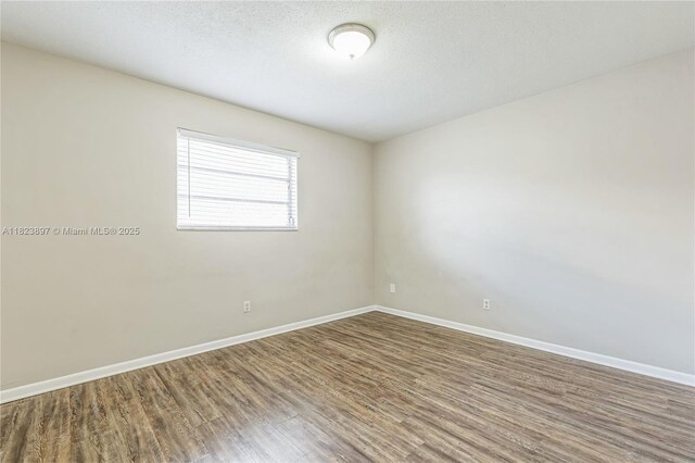 156 SW 126th Ave, Plantation, FL 33325 - empty room with wood finished floors and baseboards