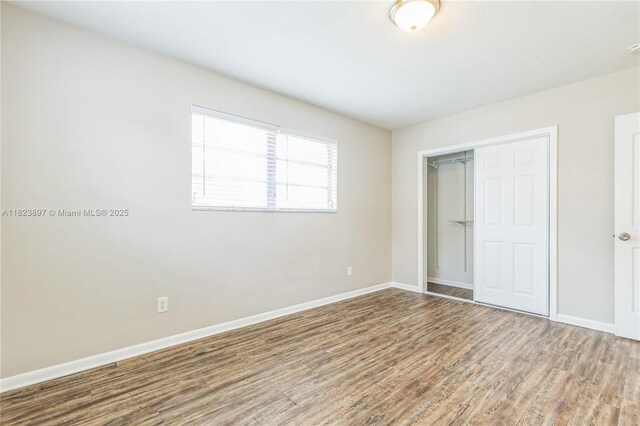 156 SW 126th Ave, Plantation, FL 33325 - unfurnished bedroom featuring wood finished floors and a closet