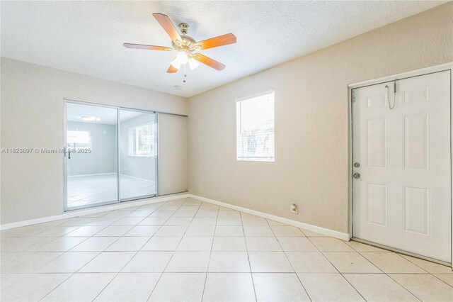 156 SW 126th Ave, Plantation, FL 33325 - unfurnished room featuring a ceiling fan, a textured ceiling, a textured wall, and light tile patterned floors