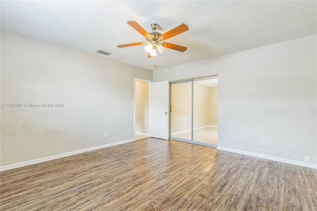 156 SW 126th Ave, Plantation, FL 33325 - unfurnished bedroom with wood finished floors, a closet, and a ceiling fan