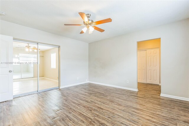 156 SW 126th Ave, Plantation, FL 33325 - unfurnished bedroom featuring wood finished floors, a ceiling fan, and a closet