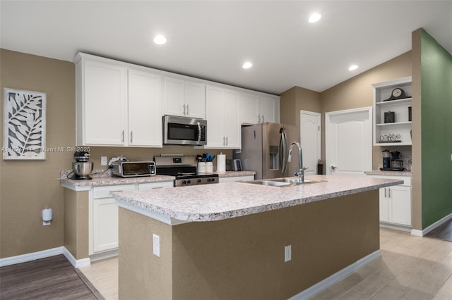 4728 Adrienne St, Sebring, FL 33872 - kitchen with stainless steel appliances, open shelves, a center island with sink, light countertops, and white cabinets