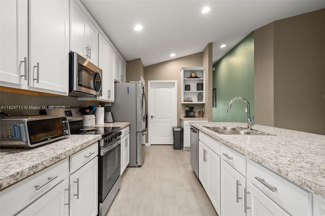 4728 Adrienne St, Sebring, FL 33872 - kitchen with appliances with stainless steel finishes, open shelves, light countertops, lofted ceiling, and white cabinetry