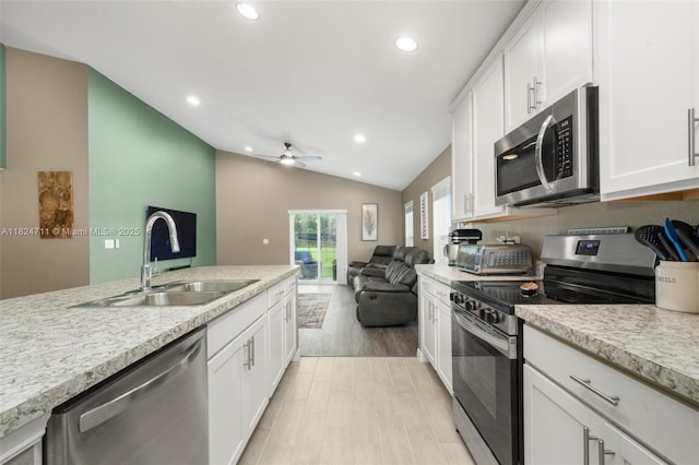 4728 Adrienne St, Sebring, FL 33872 - kitchen featuring appliances with stainless steel finishes, light countertops, ceiling fan, white cabinets, and open floor plan