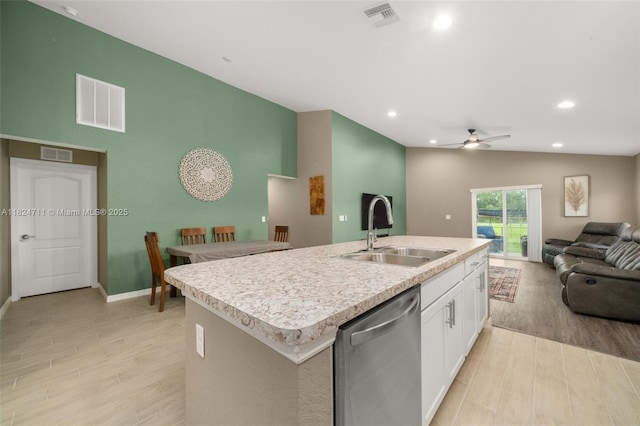 4728 Adrienne St, Sebring, FL 33872 - kitchen with stainless steel dishwasher, open floor plan, an island with sink, a ceiling fan, and light wood-style floors
