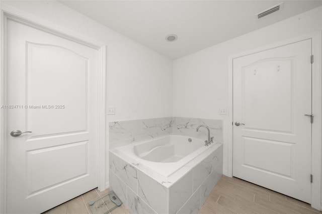 4728 Adrienne St, Sebring, FL 33872 - full bath featuring a bath and wood finish floors