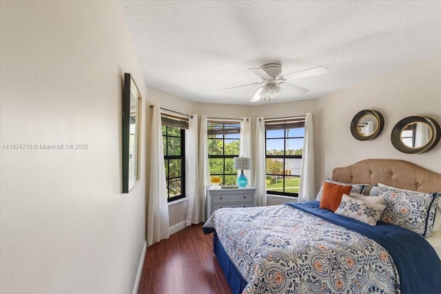 1273 SW 161st Ave, Pembroke Pines, FL 33027 - bedroom featuring multiple windows, dark wood-type flooring, a textured ceiling, and a ceiling fan