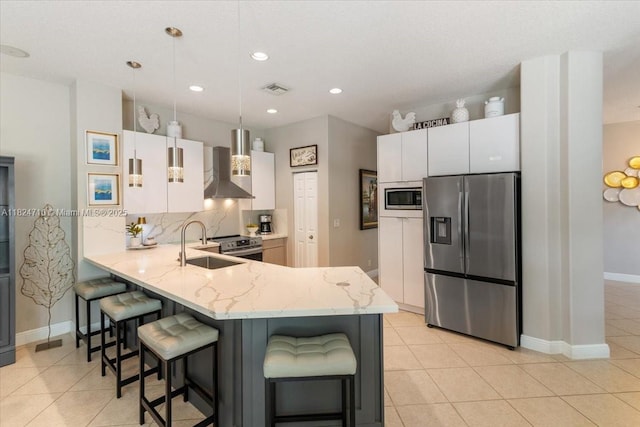 1273 SW 161st Ave, Pembroke Pines, FL 33027 - kitchen with appliances with stainless steel finishes, wall chimney exhaust hood, a peninsula, a breakfast bar, and recessed lighting
