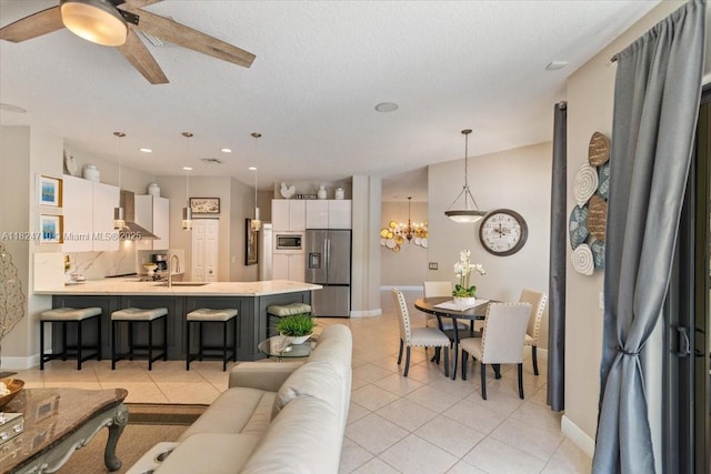 1273 SW 161st Ave, Pembroke Pines, FL 33027 - living area featuring light tile patterned flooring, a ceiling fan, a chandelier, recessed lighting, and a textured ceiling