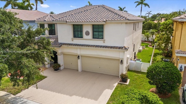 1273 SW 161st Ave, Pembroke Pines, FL 33027 - mediterranean / spanish-style house with a tiled roof, decorative driveway, an attached garage, and stucco siding