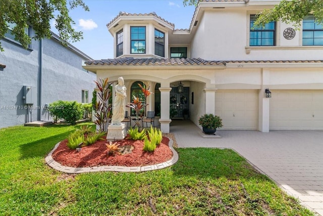 1273 SW 161st Ave, Pembroke Pines, FL 33027 - view of front of property with decorative driveway, stucco siding, an attached garage, and a front yard