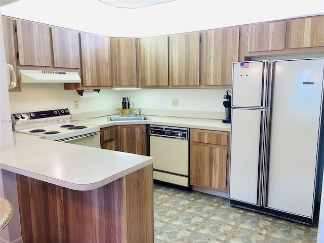 224 Pine Hov Cir Unit D-2, Green Acres, FL 33463 - kitchen with white appliances, under cabinet range hood, a peninsula, and light countertops