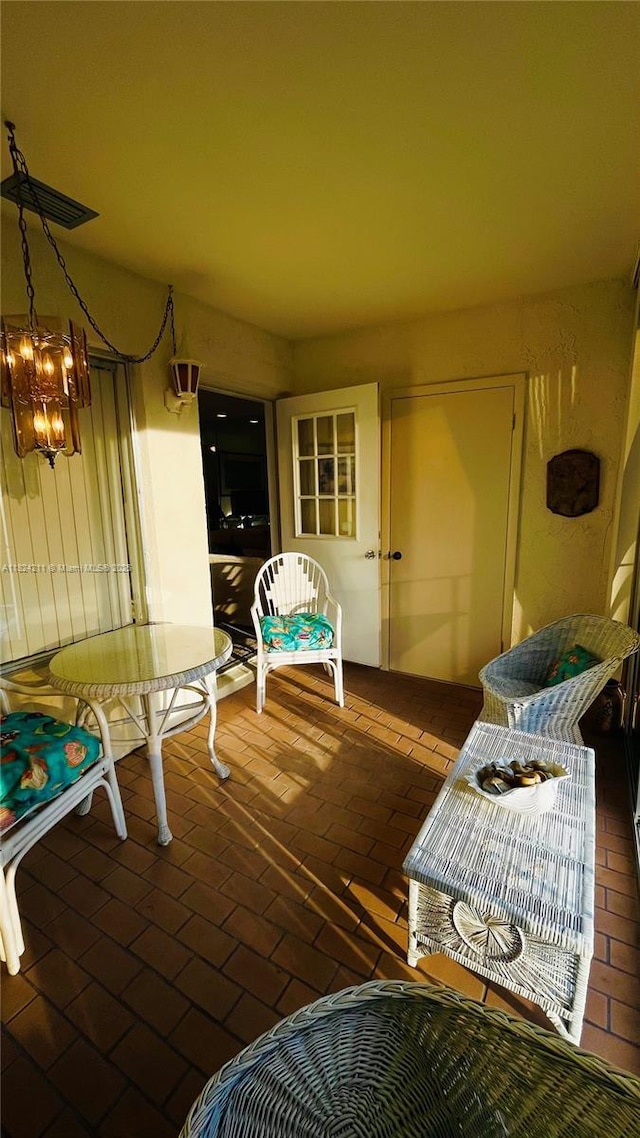 224 Pine Hov Cir Unit D-2, Green Acres, FL 33463 - dining area featuring brick floors and a chandelier