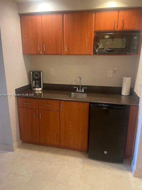 18001 Collins Ave Unit 502, Sunny Isles Beach, FL 33160 - kitchen with black appliances and brown cabinets