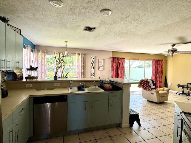 17088 NW 19th St, Pembroke Pines, FL 33028 - kitchen featuring dishwasher, a peninsula, a textured ceiling, light tile patterned floors, and a ceiling fan