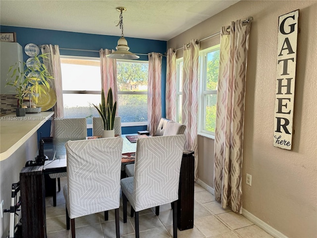 17088 NW 19th St, Pembroke Pines, FL 33028 - dining room featuring light tile patterned flooring, a textured ceiling, and a textured wall