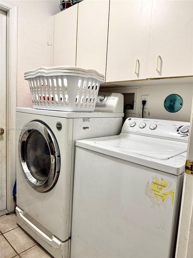 17088 NW 19th St, Pembroke Pines, FL 33028 - laundry area with independent washer and dryer, light tile patterned flooring, and cabinet space