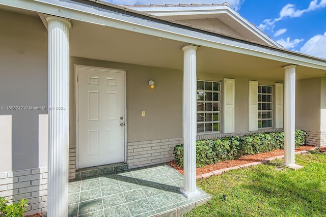 1708 NW 84th Dr, Coral Springs, FL 33071 - view of exterior entry with brick siding and a porch