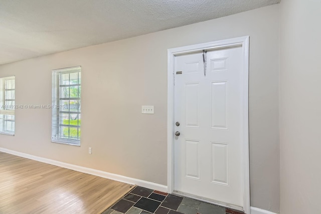 1708 NW 84th Dr, Coral Springs, FL 33071 - entryway with baseboards and dark wood-type flooring