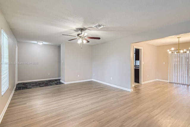 1708 NW 84th Dr, Coral Springs, FL 33071 - spare room with ceiling fan, a chandelier, light wood finished floors, and a textured ceiling