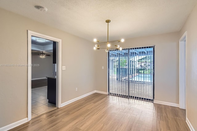 1708 NW 84th Dr, Coral Springs, FL 33071 - unfurnished dining area with wood finished floors, a chandelier, a textured ceiling, and ceiling fan
