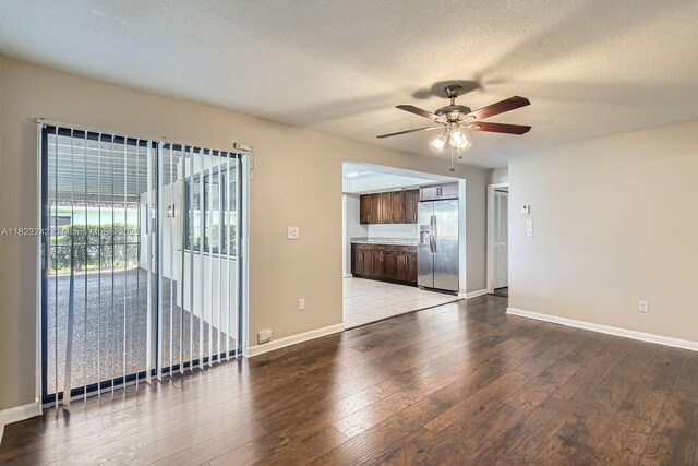 1708 NW 84th Dr, Coral Springs, FL 33071 - unfurnished living room featuring ceiling fan, wood finished floors, and a textured ceiling