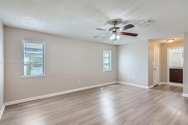 1708 NW 84th Dr, Coral Springs, FL 33071 - spare room with light wood-type flooring, a textured ceiling, and ceiling fan