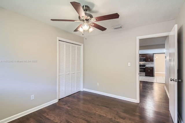 1708 NW 84th Dr, Coral Springs, FL 33071 - unfurnished bedroom with a closet, wood finished floors, and a ceiling fan