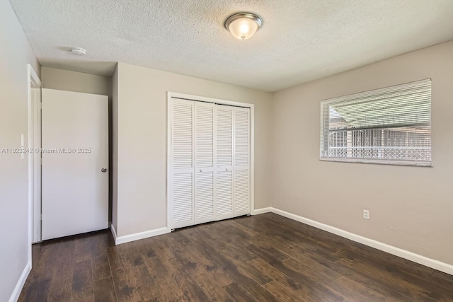 1708 NW 84th Dr, Coral Springs, FL 33071 - unfurnished bedroom featuring a closet, dark wood-style flooring, and a textured ceiling