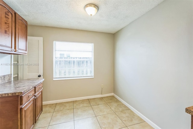 22226 SW 62nd Ave, Boca Raton, FL 33428 - unfurnished dining area with a textured ceiling and light tile patterned floors