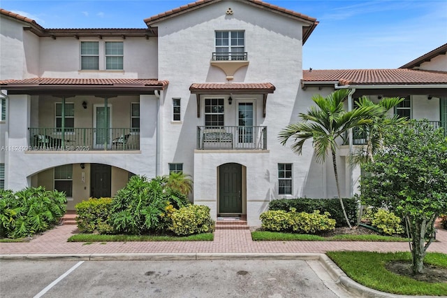 11854 SW 27th St, Miramar, FL 33025 - view of front of house with stucco siding, a tiled roof, and a balcony