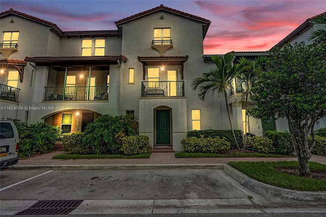 11854 SW 27th St, Miramar, FL 33025 - view of front of house featuring a balcony, stucco siding, uncovered parking, and a tile roof