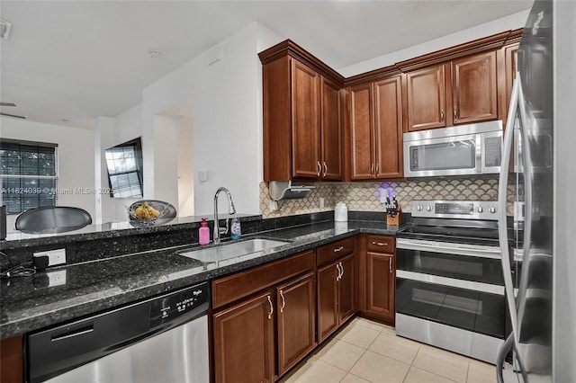 11854 SW 27th St, Miramar, FL 33025 - kitchen featuring appliances with stainless steel finishes, dark stone counters, light tile patterned floors, and backsplash