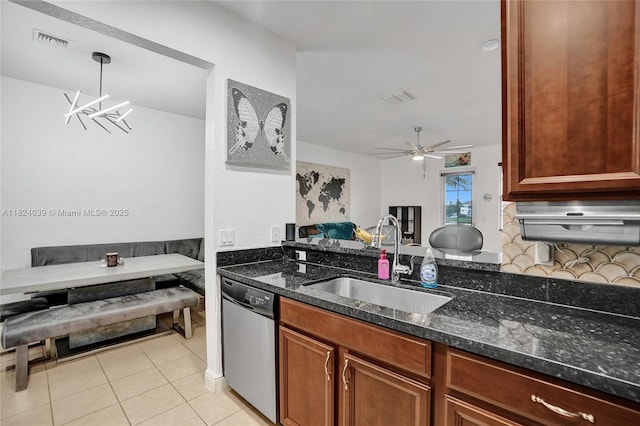 11854 SW 27th St, Miramar, FL 33025 - kitchen with dishwasher, dark stone countertops, open floor plan, light tile patterned floors, and a ceiling fan