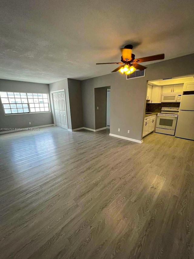 3515 Van Buren St Unit 106, Hollywood, FL 33021 - unfurnished living room featuring light wood finished floors, a textured ceiling, and ceiling fan