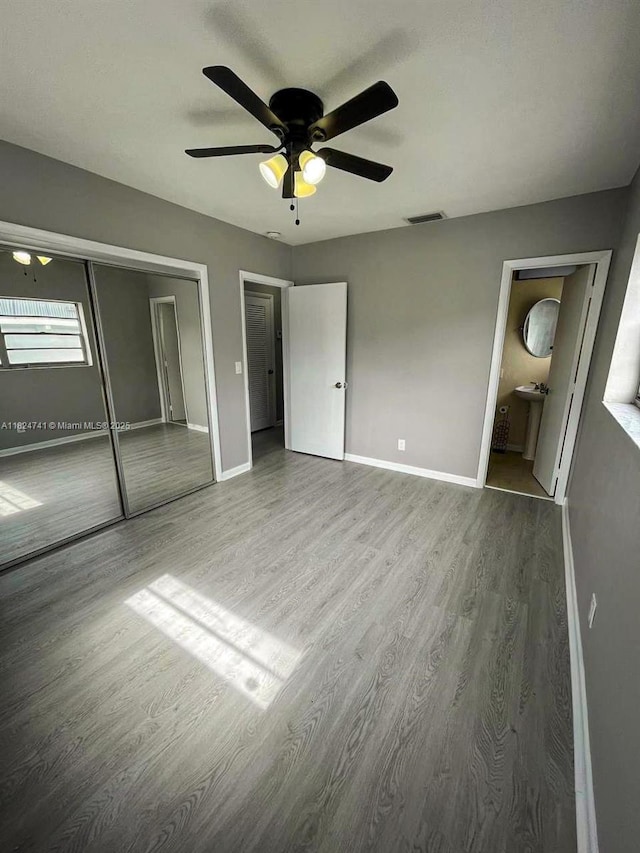 3515 Van Buren St Unit 106, Hollywood, FL 33021 - unfurnished bedroom with wood finished floors, ceiling fan, and ensuite bath