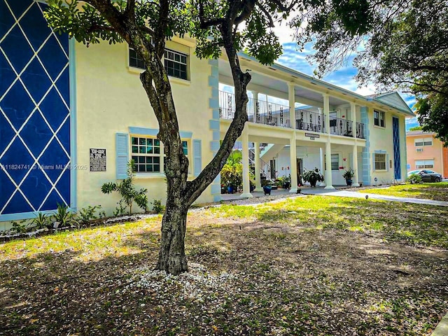 3515 Van Buren St Unit 106, Hollywood, FL 33021 - view of front facade featuring stucco siding, a balcony, and stairway