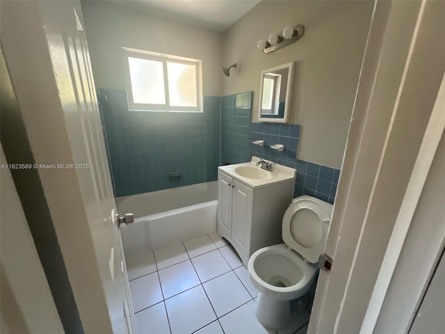 3841 NW 7th Ct, Lauderhill, FL 33311 - full bathroom with tile patterned flooring, vanity, tile walls, shower / bath combination, and a wainscoted wall
