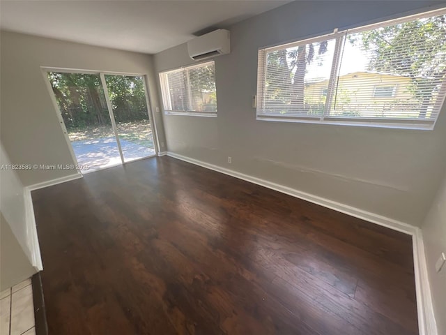 3841 NW 7th Ct, Lauderhill, FL 33311 - spare room featuring a wall unit AC, wood finished floors, and healthy amount of natural light