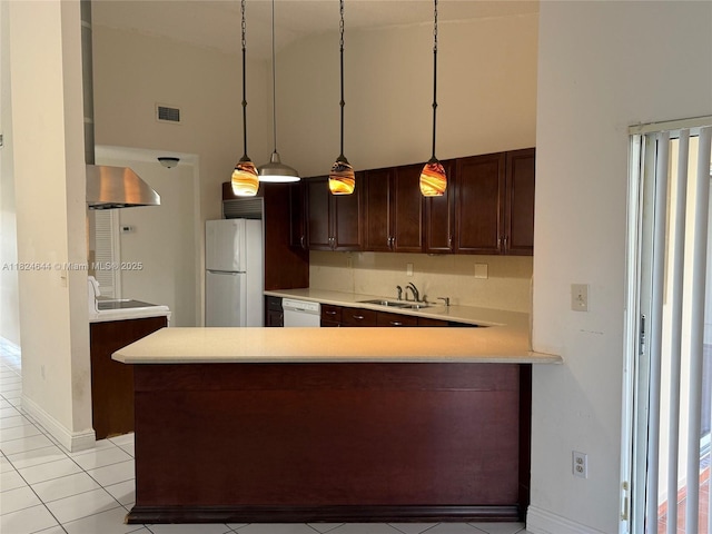 651 NW 134th Ave, Miami, FL 33182 - kitchen featuring white appliances, light countertops, a peninsula, wall chimney exhaust hood, and light tile patterned flooring