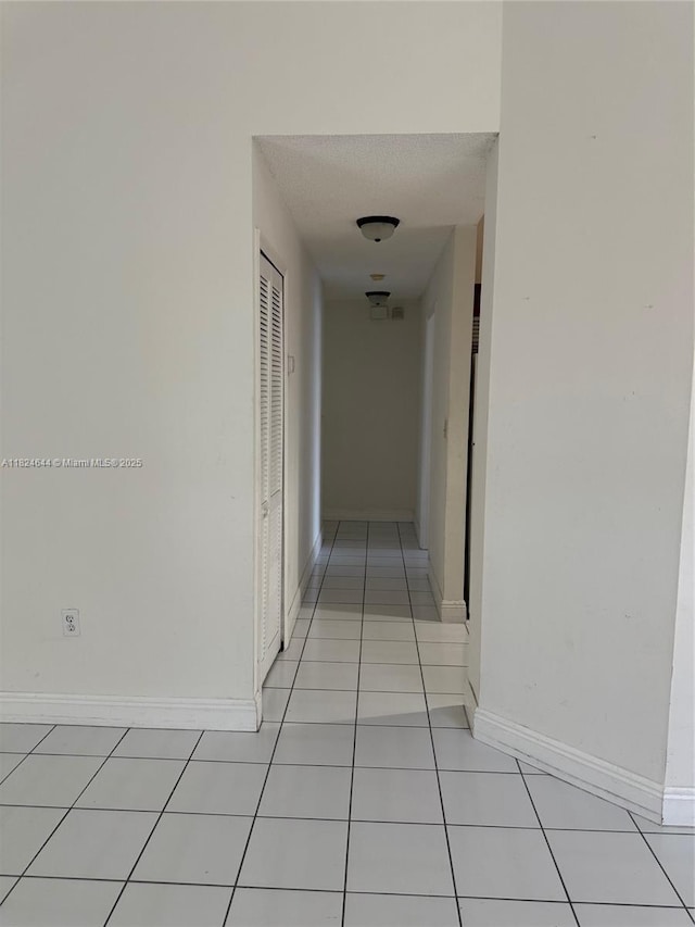 651 NW 134th Ave, Miami, FL 33182 - corridor with light tile patterned floors and a textured ceiling