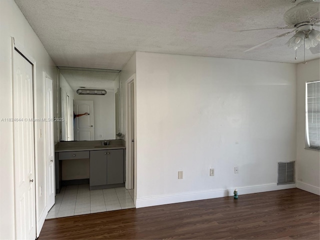 651 NW 134th Ave, Miami, FL 33182 - unfurnished living room with light wood-style flooring, ceiling fan, and a textured ceiling