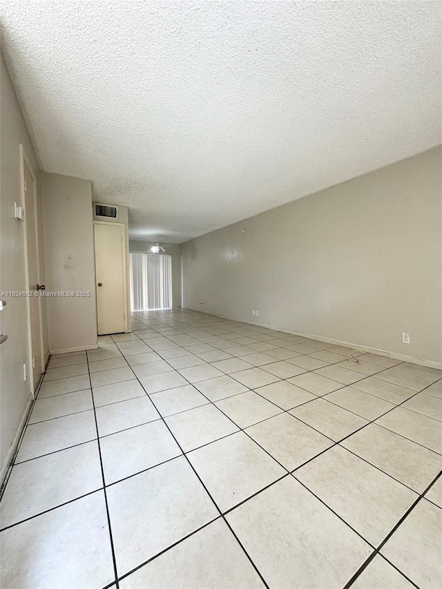 2562 NW 52nd Ave Unit B18, Lauderhill, FL 33313 - empty room featuring a textured ceiling and light tile patterned floors
